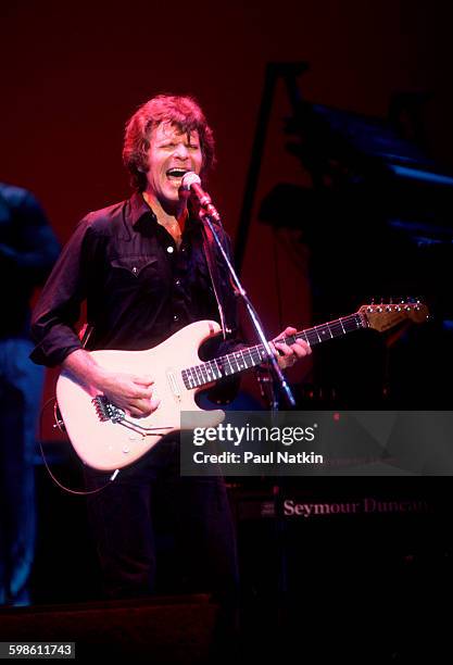 American Rock musician John Fogerty plays guitar as he performs onstage, Philadelphia, Pennsylvania, September 6, 1986.