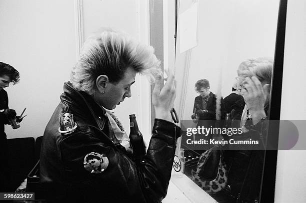 Singer and guitarist Brian Setzer of American rockabilly band the Stray Cats, backstage at Manchester University, 7th March 1981. On the left, and...