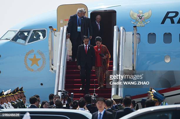 Indonesian President Joko Widodo walks down a gangway after his plane arrived at Hangzhou Xiaoshan International Airport on September 2, 2016. / AFP...