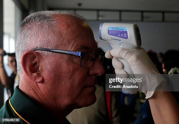 Health workers use thermal imaging equipment to detect abnormal body temperatures to screen travelers from neighboring Singapore for the...