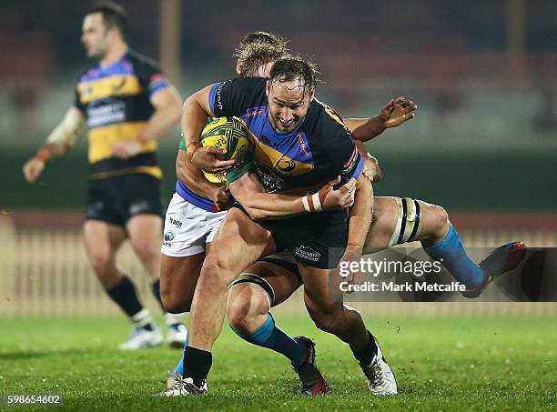 Billy Meakes of the Spirit is tackled during the round two NRC match between the Sydney Rays and the Perth Spirit at North Sydney Oval on September...