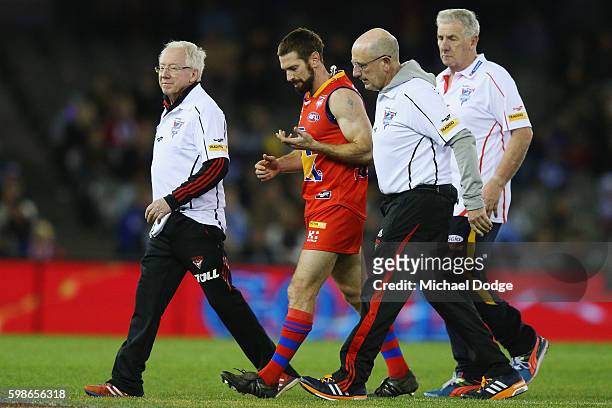Jason Akermanis of the All Stars walks off after sustaining an injury in a contest during the EJ Whitten Legends match at Etihad Stadium on September...