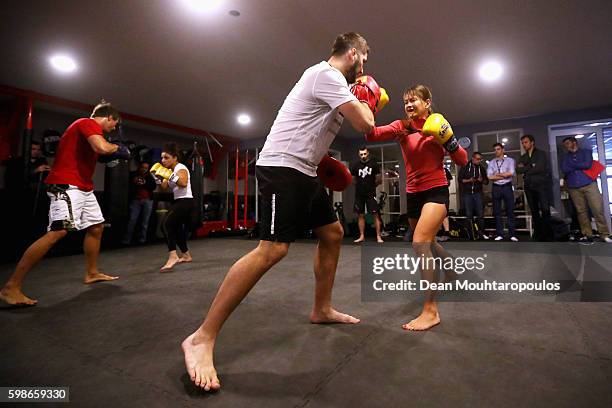 Susianna "Susi" Levonovna Kentikian of Germany and Armenia and Karolina Kowalkiewicz of Poland spar with their coaches during the UFC Open Workout...