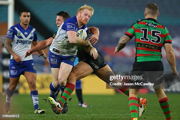 James Graham of the Bulldogs is tackled during the round 26 NRL match between the Canterbury Bulldogs and the South Sydney Rabbitohs at ANZ Stadium...