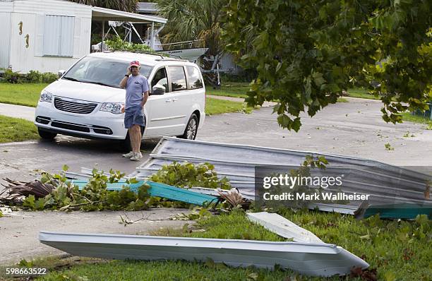 Residents check the damage in their neighborhood after Hurricane Hermaine came ashore on September 2, 2016 in Shell Point Beach, Florida. Hermine...