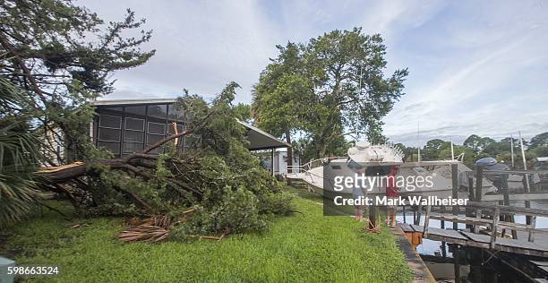 Residents check the damage in their neighborhood after Hurricane Hermaine came ashore on September 2, 2016 in Shell Point Beach, Florida. Hermine...