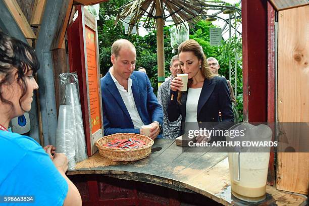 Britain's Catherine, Duchess of Cambridge and Britain's Prince William, Duke of Cambridge sample a cup of baobab, a tropical Malawian fruit drink, in...