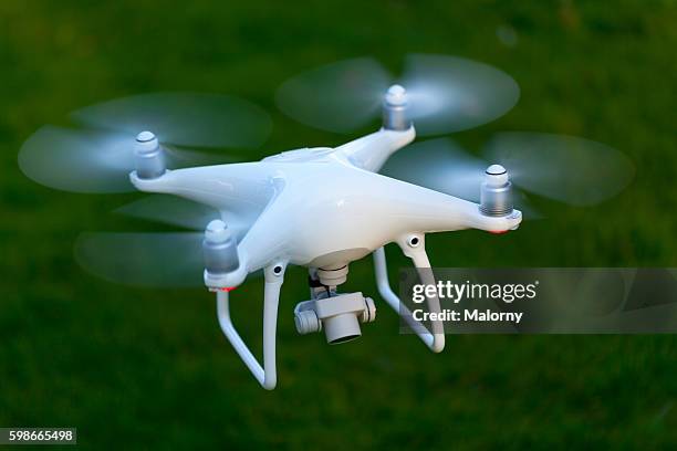 flying drone with camera. - drone foto e immagini stock