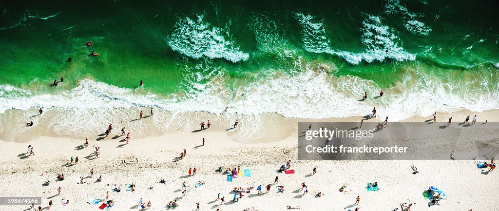 Crowds sunbathing on the beach in miami