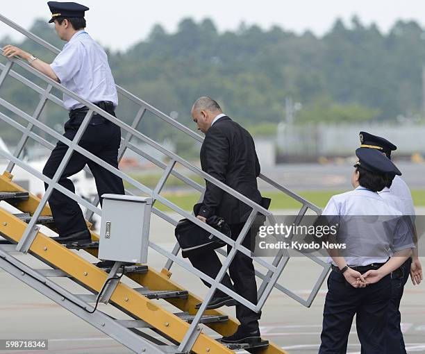 Japan - Govinda Prasad Mainali , a Nepalese man granted a retrial over a 1997 Tokyo murder case, climbs up the stairs into an airplane at Narita...