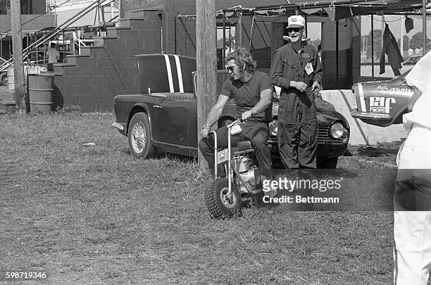 Driver Steve McQueen gets the pit crews laughing as he spins around on a mini-bike with his leg in a cast. The Los Angeles based driver broke his...