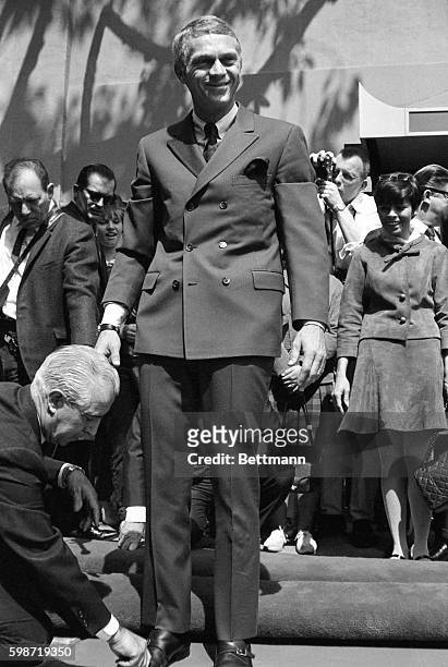 Actor Steve McQueen, his wife Neile at his side , joined the select group of screen stars, by adding his name and footprints to the forecourt of...