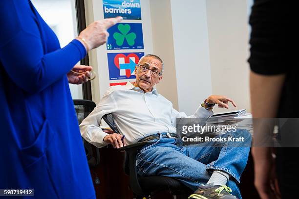 John Podesta, Campaign Chairman for Democratic presidential candidate Hillary Clinton, talks with staff at campaign headquarters, June 28, 2016 in...