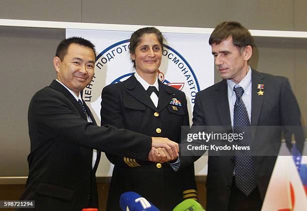 Russia - Japanese astronaut Akihiko Hoshide, NASA astronaut Sunita Williams and Russian cosmonaut Yuri Malenchenko shake hands at a press conference...