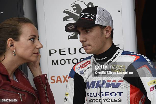 Albert Arenas of Spain and Peugeot Saxoprint MC speaks in the pit with a journalist during the MotoGp Of Great Britain - Free Practice at Silverstone...