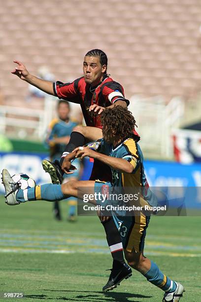 Cobi Jones of the Los Angeles Galaxy tangles with Daniel Hernandez of the New York/New Jersey MetroStars during the second half of the MLS...
