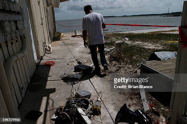 Peter Stafani, owner of the Cedar Cove resort, surveys damage to his property left behind by the winds and storm surge associated with Hurricane...