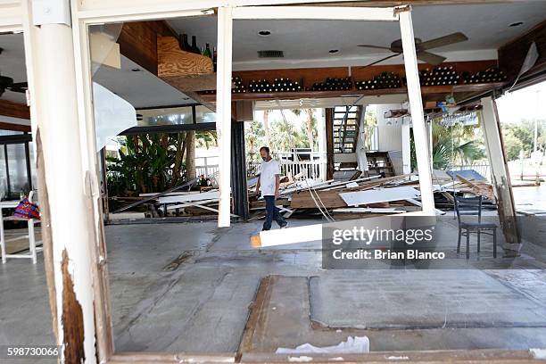 Peter Stafani, owner of the Cedar Cove resort, surveys damage to what had been the bar area of his property left behind by the winds and storm surge...