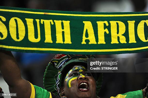 South Africa's supporter holds a club flag during the African Cup of Nation qualifier match between South Africa and Mauritania at Mbombela Stadium...