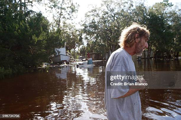 Resident surveys damage around his home from high winds and storm surge associated with Hurricane Hermine which made landfall overnight in the area...