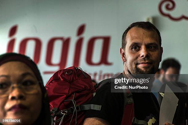 Some passenger from Singapore check passport after check body temperature with thermometer infrared by security health worker airport in Adi Sucipto...