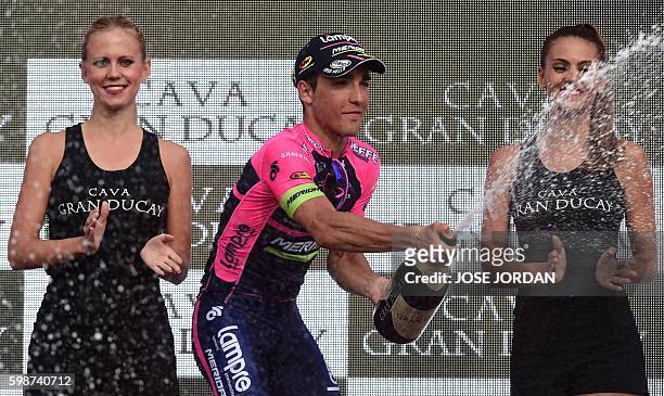 Lampre-Merida's Italian cyclist Valerio Conti celebrates on the podium after winning the 13th stage of the 71st edition of "La Vuelta" Tour of Spain,...