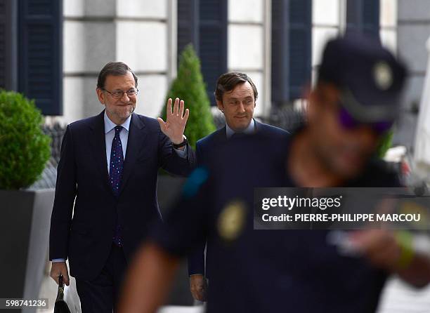 Spain's interim Prime Minister, Mariano Rajoy waves as he arrives at the Spanish Congress on September 2 in Madrid to attend the third day of a...