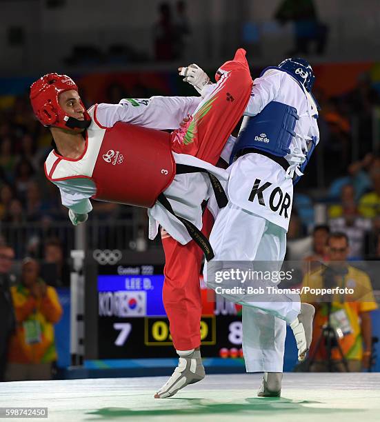 Daehoon Lee of Korea competes against Ahmad Abughaush of Jordan during their 68Kg Quarterfinal Taekwondo contest at the Carioca Arena on Day 13 of...