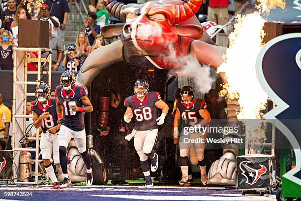 DeAndre Hopkins and Tony Bergstrom of the Houston Texans run out onto the field before a preseason game against the Arizona Cardinals at NRG Stadium...