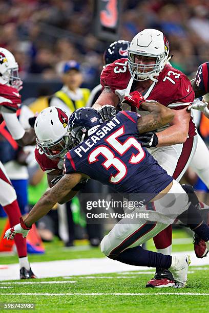 John Wetzel of the Arizona Cardinals blocks out Eddie Pleasant of the Houston Texans from the play during a preseason game at NRG Stadium on August...