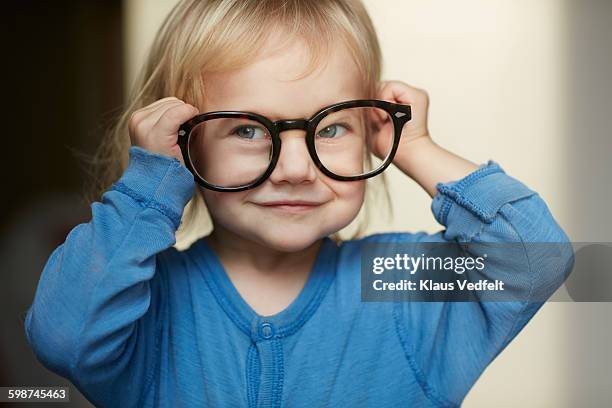 cute little girl wearing adult glasses - loose ストックフォトと画像