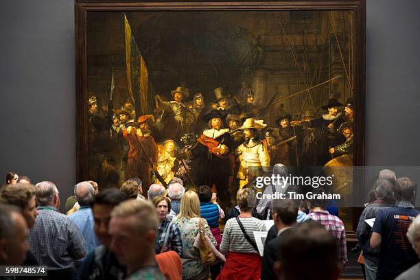 Visitors view famous 17th Century painting by Rembrandt 'The Night Watch' at Rijksmuseum in Amsterdam, Holland.