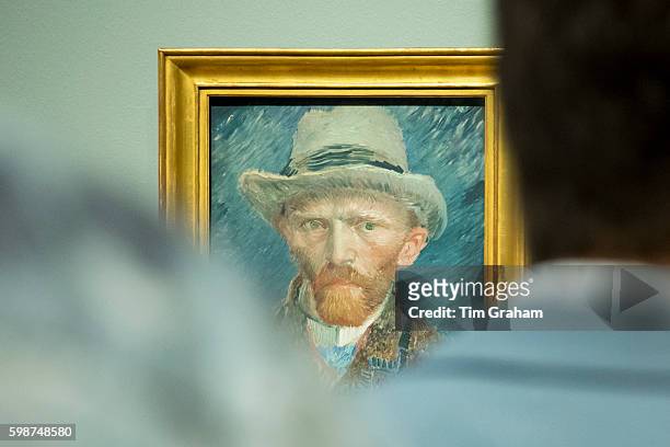 Visitors viewing self portrait by Vincent Van Gogh at Rijksmuseum, Amsterdam. , Holland.