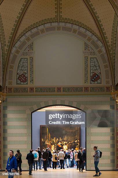 Visitors view famous 17th Century painting by Rembrandt 'The Night Watch' at Rijksmuseum in Amsterdam, Holland.