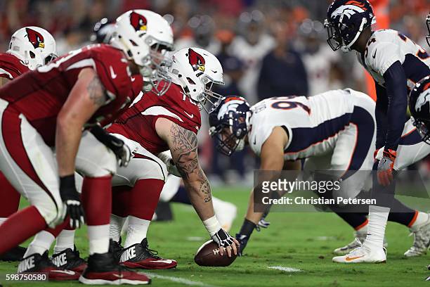 Center Evan Boehm of the Arizona Cardinals prepares to snap the football during the preseaon NFL game against the Denver Broncos at the University of...