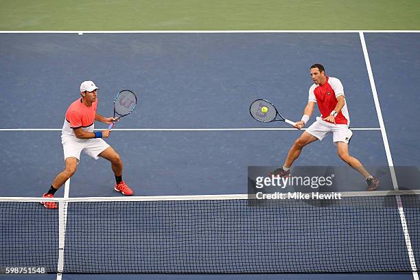 Santiago Gonzalez of Mexico and Jonathan Erlich of Israel in action against Bob Bryan and Mike Bryan of the United States during their second round...