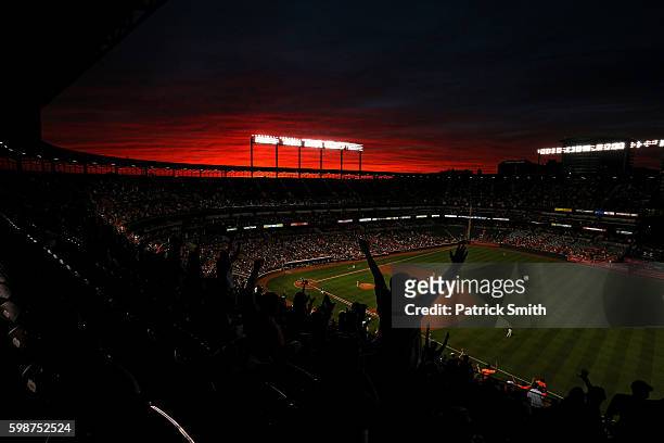 Fans cheer under a sunset as Pedro Alvarez of the Baltimore Orioles rounds the bases after hitting a two run home run against the New York Yankees...
