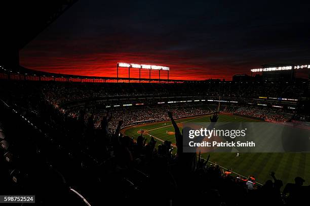 Fans cheer under a sunset as Pedro Alvarez of the Baltimore Orioles rounds the bases after hitting a two run home run against the New York Yankees...