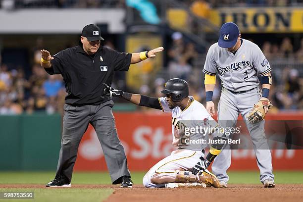 Starling Marte of the Pittsburgh Pirates reacts after sliding in safely with a double in the fourth inning during the game against the Milwaukee...