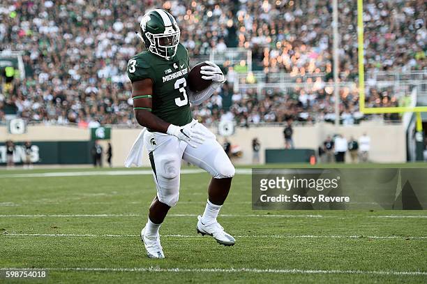 Lj Scott of the Michigan State Spartans rushes for a touchdown during the first half of a game against the Furman Paladins at Spartan Stadium on...