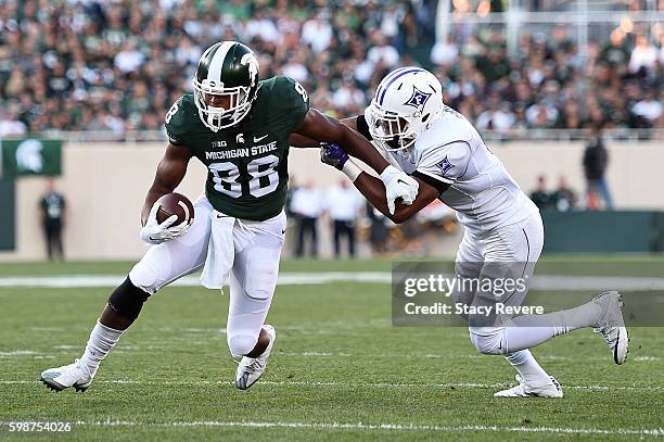 Monty Madaris of the Michigan State Spartans avoids a tackle by Thomas Brown of the Furman Paladins during the first half of a game at Spartan...