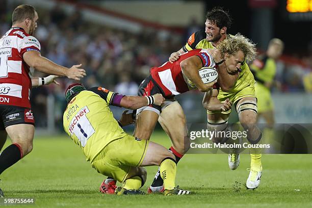 Billy Twelvetrees of Gloucester is tackled by Marcos Ayerza and Dom Barrow of Leicester Tigers during the Aviva Premiership game between Gloucester...