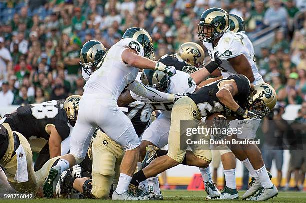 Running back Phillip Lindsay of the Colorado Buffaloes dives across the goal line for a first quarter touchdown against the Colorado State Rams at...