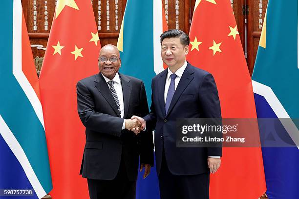 Chinese President Xi Jinping shake hands with South African President Jacob Zuma before during their meeting at the West lake State Guest House on...