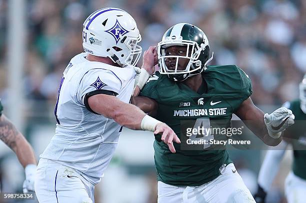 Malik McDowell of the Michigan State Spartans works against Harrison Monk of the Furman Paladins during the first half of a game at Spartan Stadium...