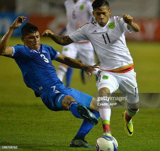 El Salvador's Roberto Carlos Domiguez and Mexico's Javier Aquino vie for the ball during their Russia 2018 FIFA World Cup Concacaf Qualifiers...