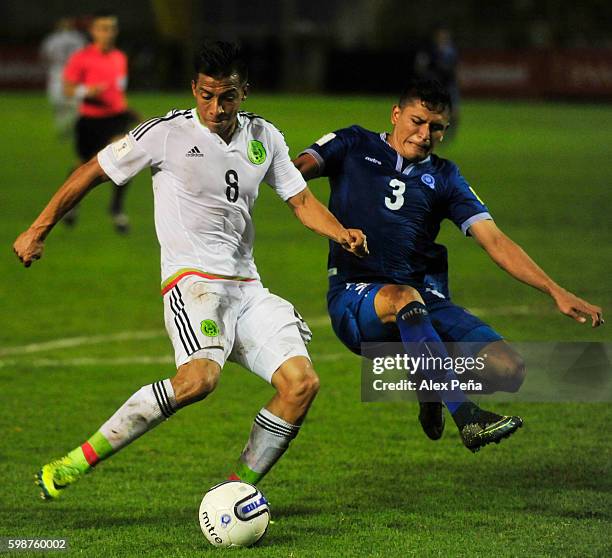 Angel Sepulveda of Mexico fights for the ball with Roberto Dominguez of El Salvador during a match between El Salvador and Mexico as part of FIFA...