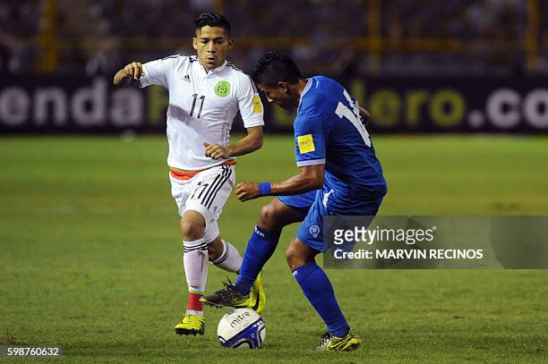 El Salvador's Oscar Ceren and Mexico's Javier Aquino vie for the ball during their Russia 2018 FIFA World Cup Concacaf Qualifiers football match, at...
