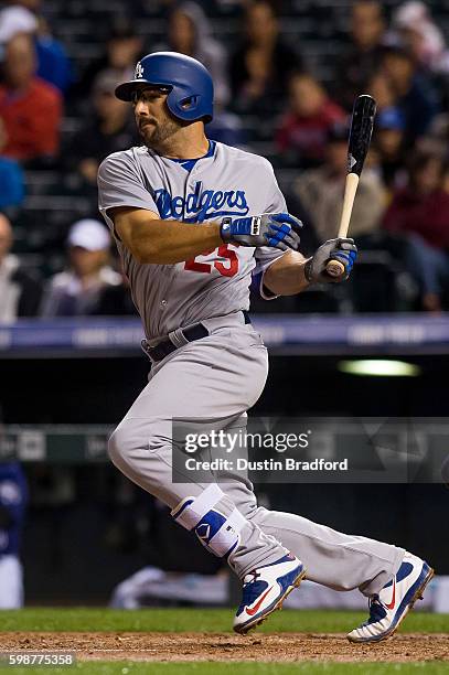 Rob Segedin of the Los Angeles Dodgers singles in the fourth inning of a game against the Colorado Rockies at Coors Field on August 29, 2016 in...