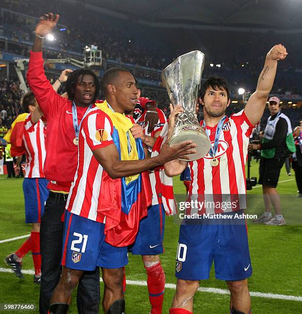 Luis Amaranto Perea and Sergio Aguero of Atletico Madrid celebrate winning the Europa League final with the trophy